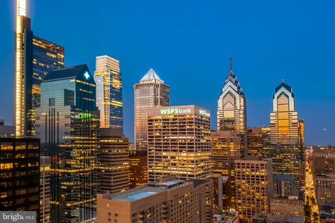 a view of swimming pool with outdoor seating and city view