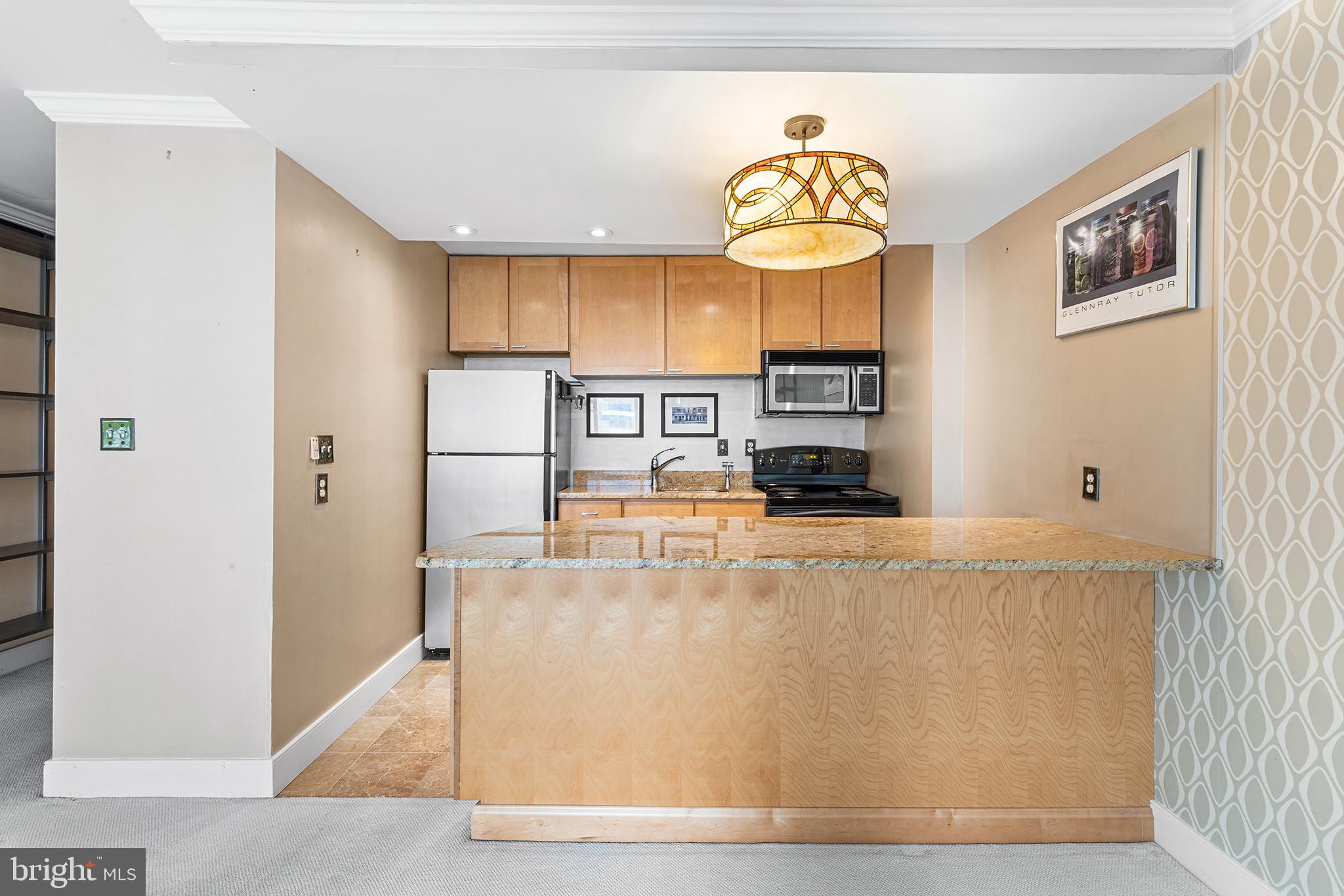 1919 Chestnut Street, Unit 202324 Philadelphia, PA 19103 - Photo 5 of 38 a view of kitchen with stainless steel appliances granite countertop cabinets and a refrigerator