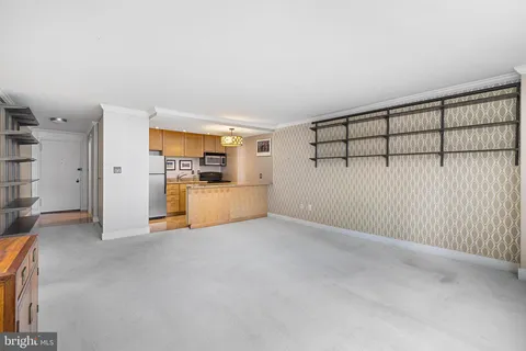 a view of a livingroom with furniture and a kitchen