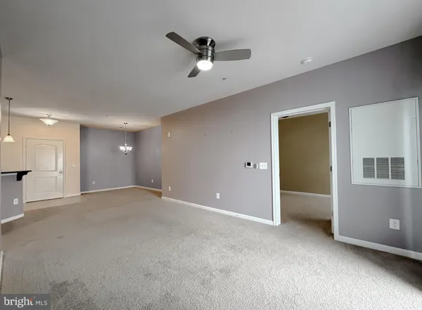 a view of an empty room with a ceiling fan