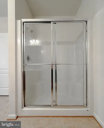 a bathroom with a glass shower door