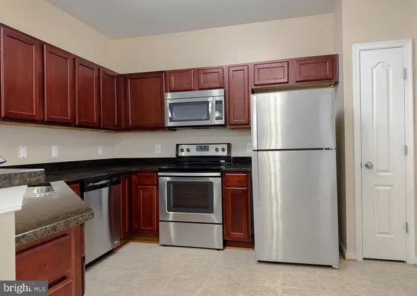 a kitchen with a refrigerator sink and microwave