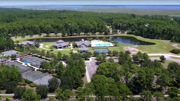 an aerial view of a house with yard swimming pool and outdoor seating