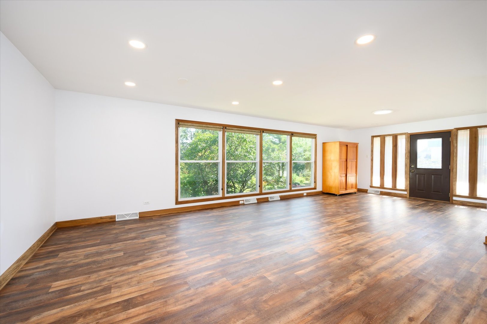 1037 Spring Road Elmhurst, IL 60126 - Photo 3 of 36 a view of empty room with wooden floor and fan