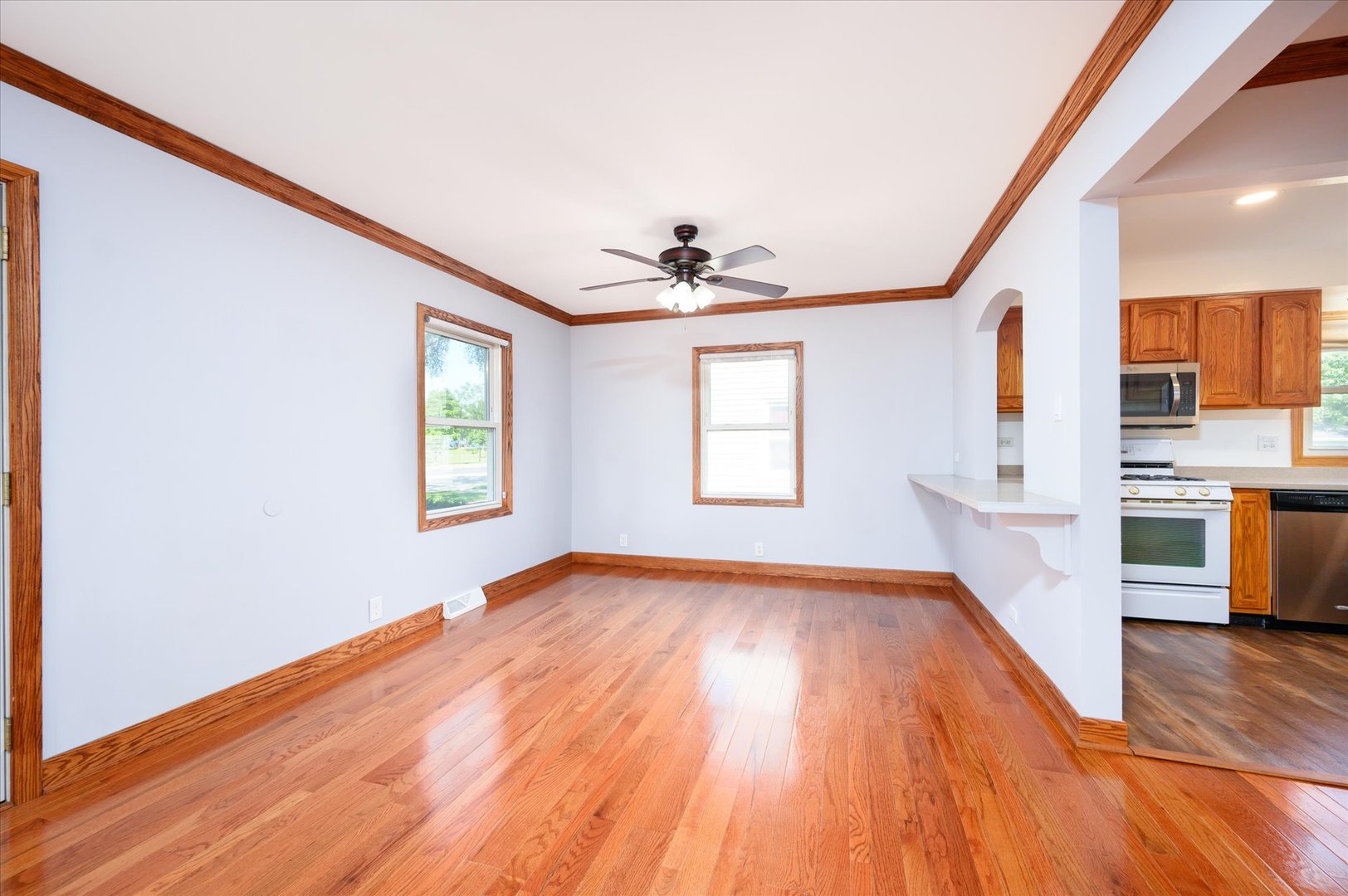 1037 Spring Road Elmhurst, IL 60126 - Photo 6 of 36 a view of an empty room with window and wooden floor