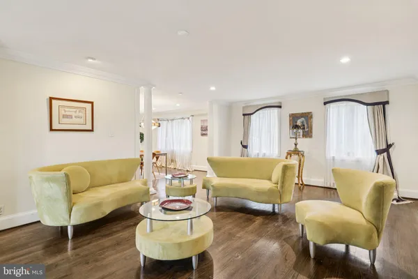 a view of walk in closet with wooden floor and windows
