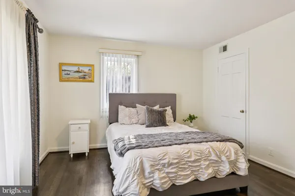 a living room with furniture and a view of kitchen