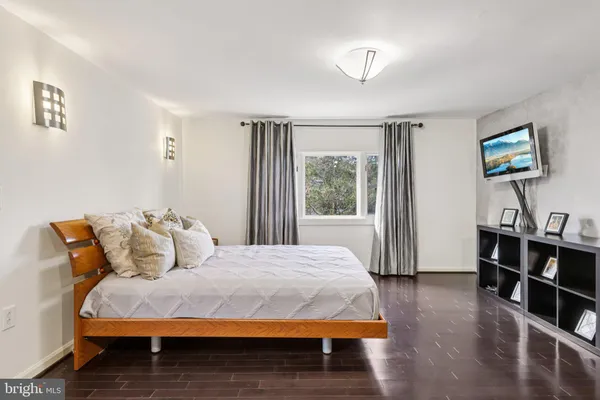 a living room with furniture and a ceiling fan