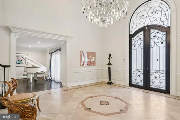 a kitchen with a dining table chairs and refrigerator