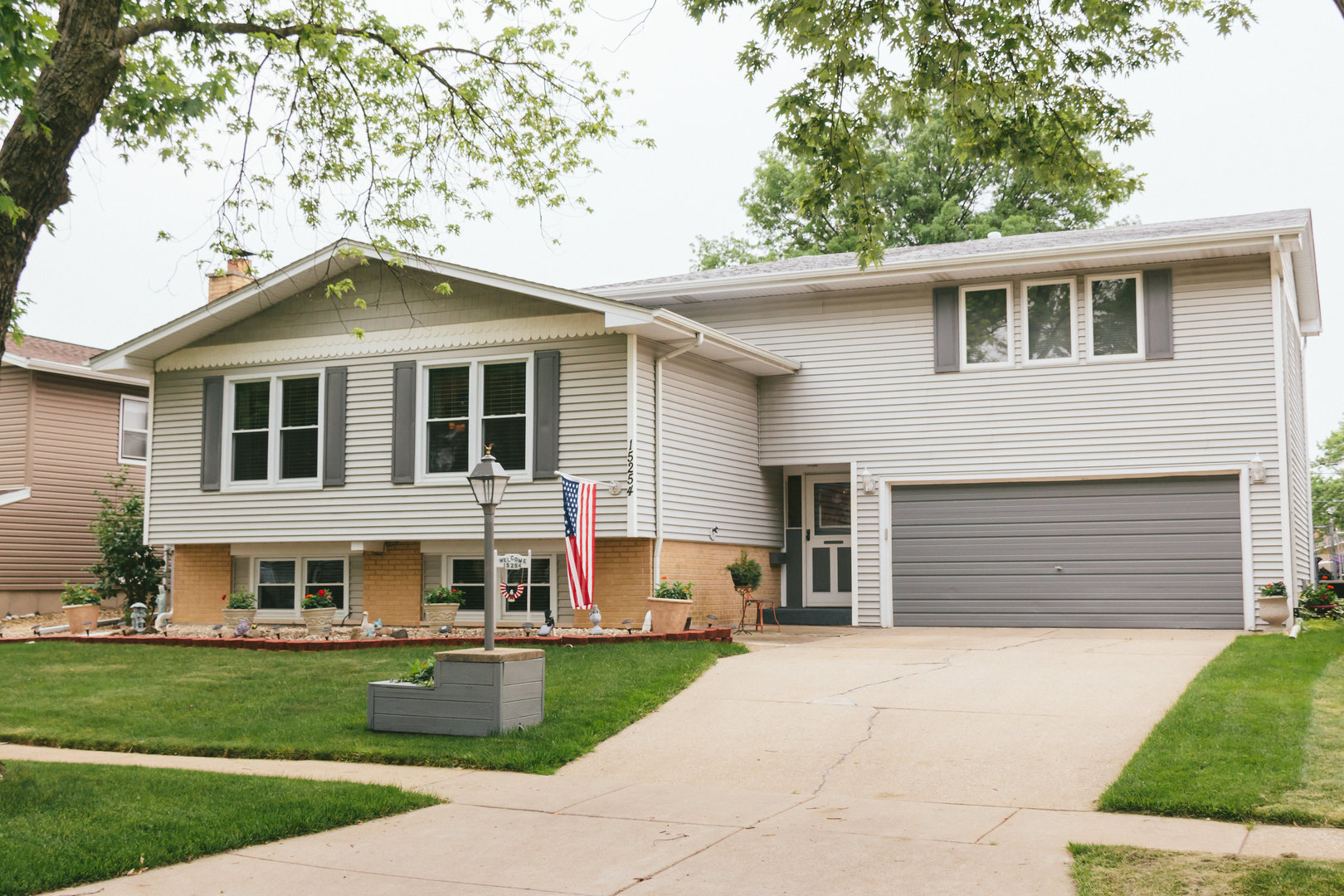 a front view of a house with a garden and yard