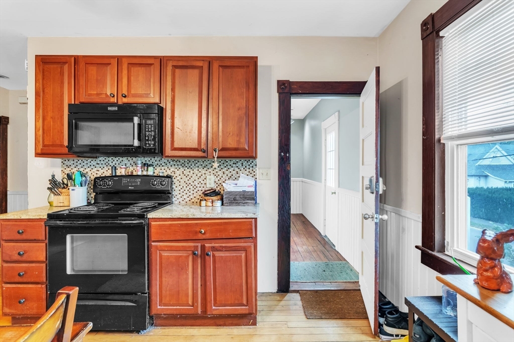 47 Harold Street North Andover, MA 01845 - Photo 14 of 38 a kitchen with wooden cabinets and a stove top oven