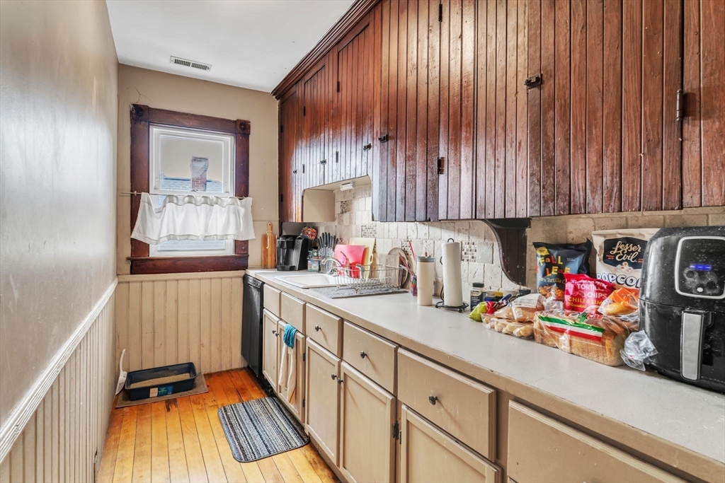 47 Harold Street North Andover, MA 01845 - Photo 16 of 38 a kitchen with granite countertop lots of clutter and stainless steel appliances
