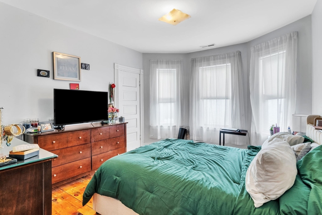 47 Harold Street North Andover, MA 01845 - Photo 17 of 38 a bedroom with a bed and a flat screen tv