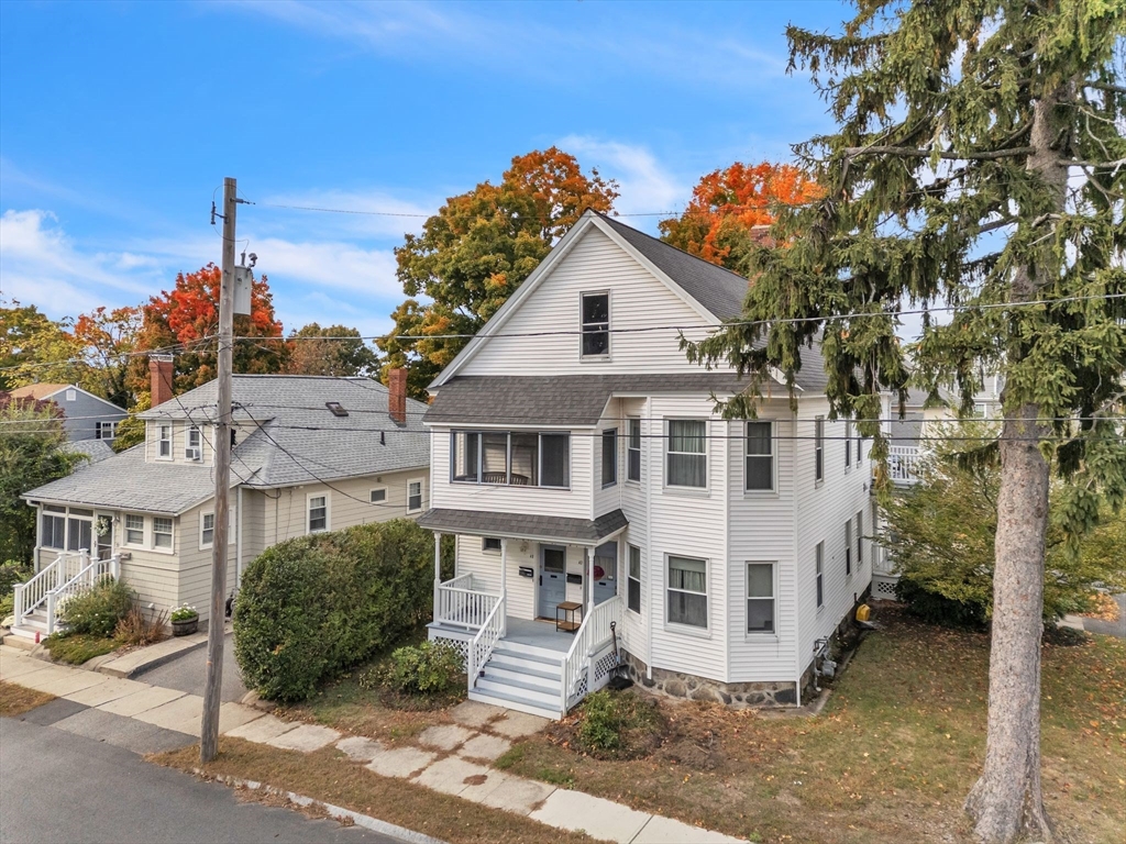 47 Harold Street North Andover, MA 01845 - Photo 2 of 38 a view of a white house next to a yard with plants and trees