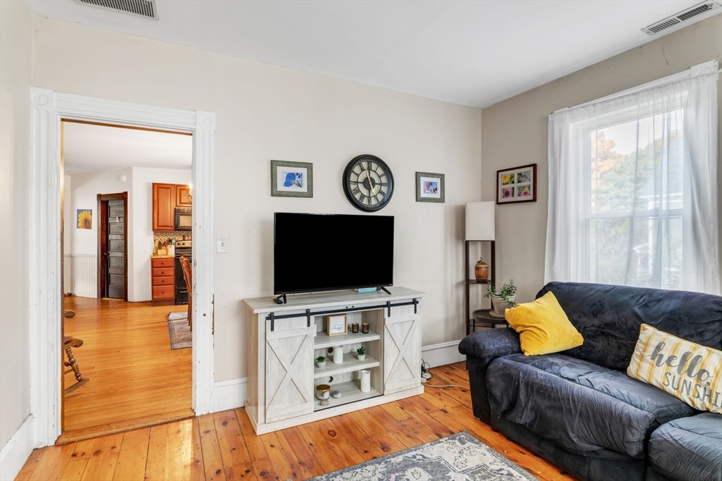 47 Harold Street North Andover, MA 01845 - Photo 8 of 38 a living room with furniture and a flat screen tv