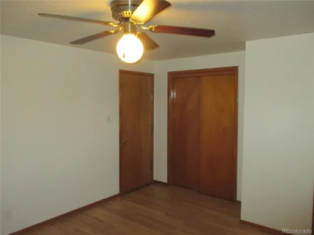 an empty room with windows and closet