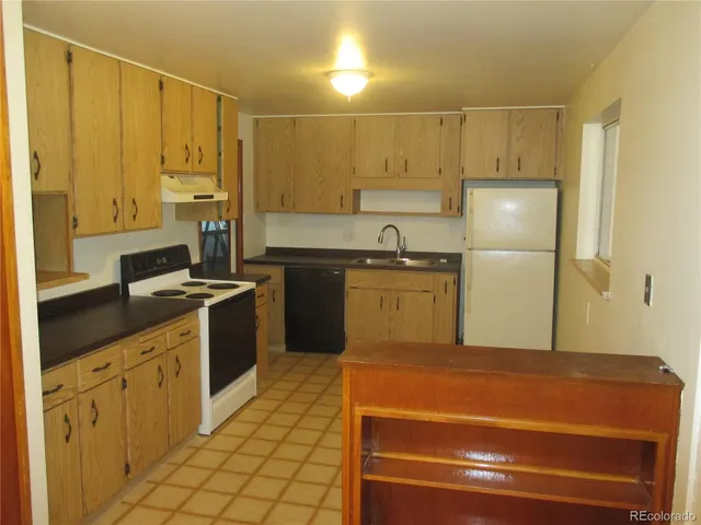a kitchen with stainless steel appliances a refrigerator sink and cabinets