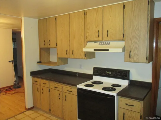 a kitchen with granite countertop cabinets and white appliances