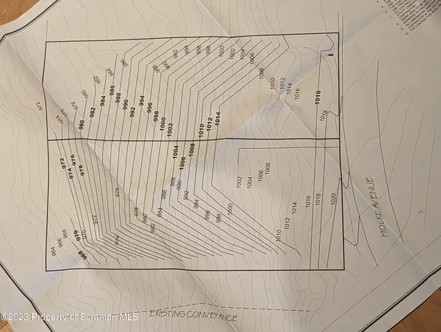 a view of a bathroom with white wall and a shower