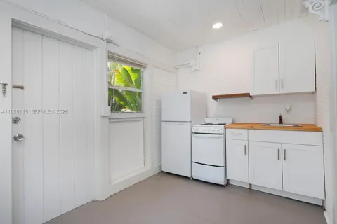 a room with white cabinets and window