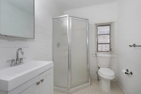 a bathroom with a toilet a sink and shower