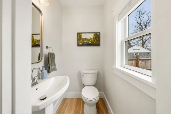 a bathroom with a toilet a sink and a mirror