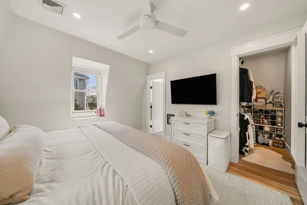 a bedroom with a flat screen tv and a bed