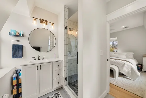 a bathroom with a double vanity sink and a mirror