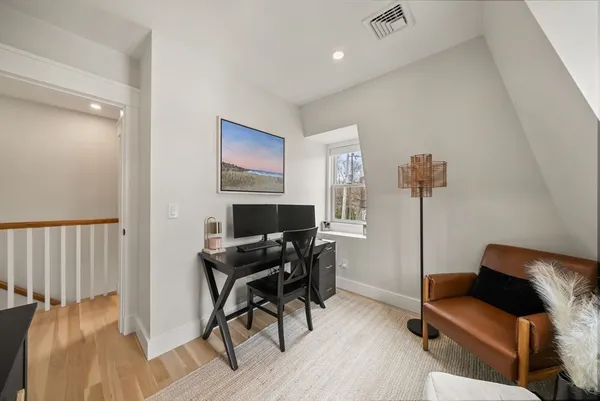 a workspace with furniture and wooden floor