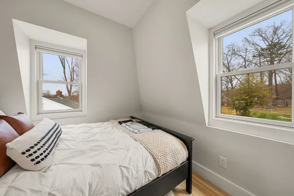 a bedroom with a bed and a painting on the wall