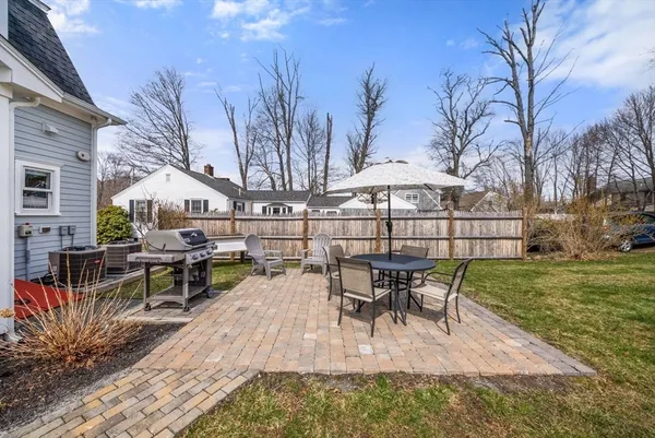 a view of a house with backyard water fountain and sitting area
