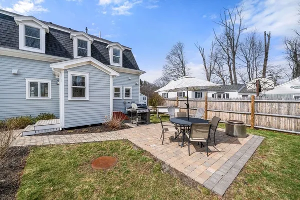 a view of a house with backyard porch and sitting area