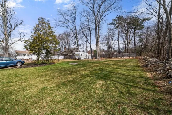 a backyard of apartments with large trees