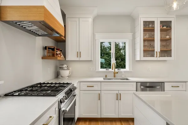 a kitchen with a sink stove and cabinets