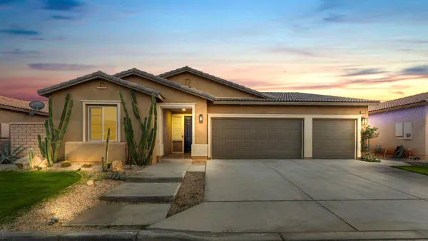 a front view of a house with a garage