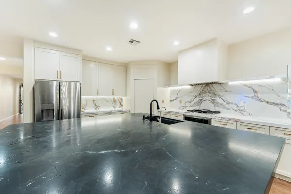 a view of a kitchen with a sink and a stove top oven