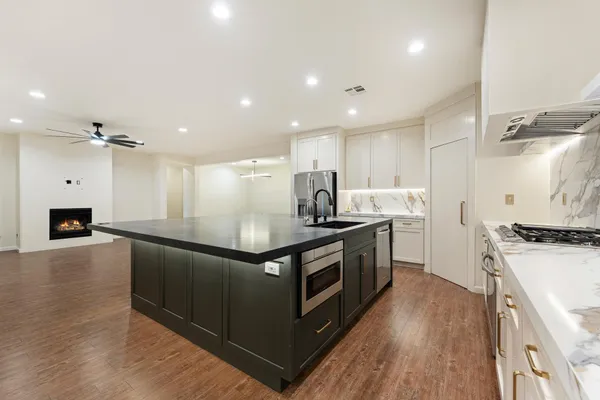 a view of a kitchen with a stove and a ceiling fan