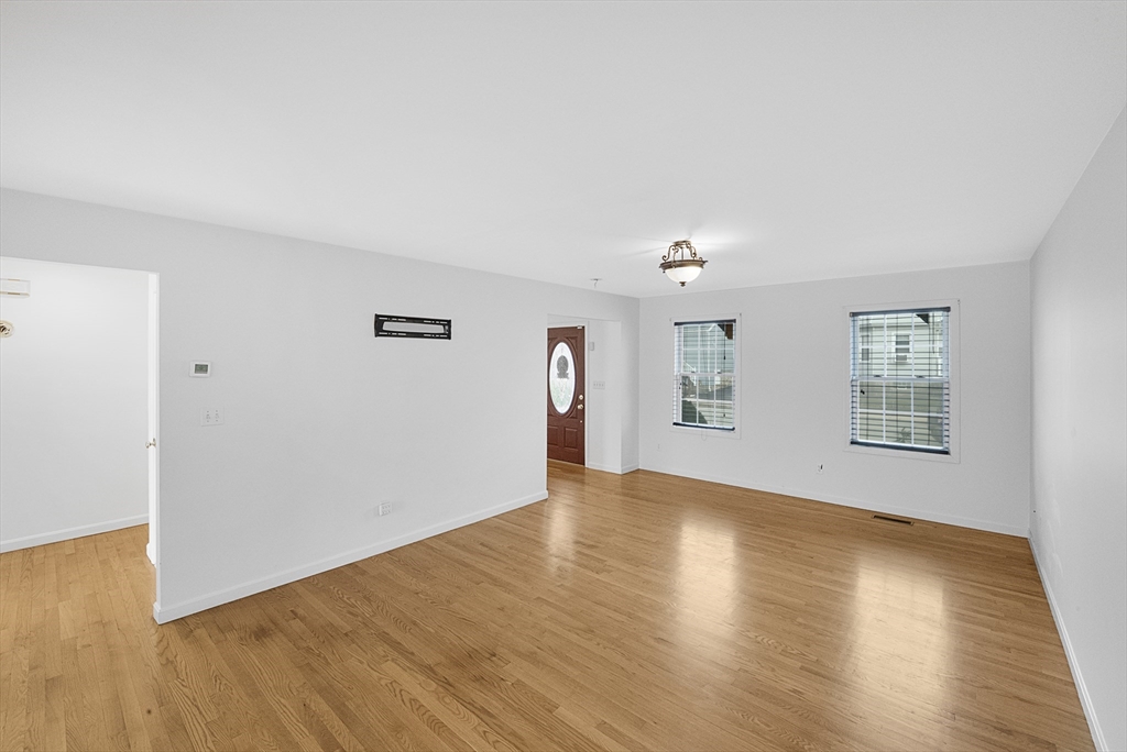 215 Cambridge Street Fall River, MA 02721 - Photo 8 of 41 a view of an empty room with wooden floor and a window