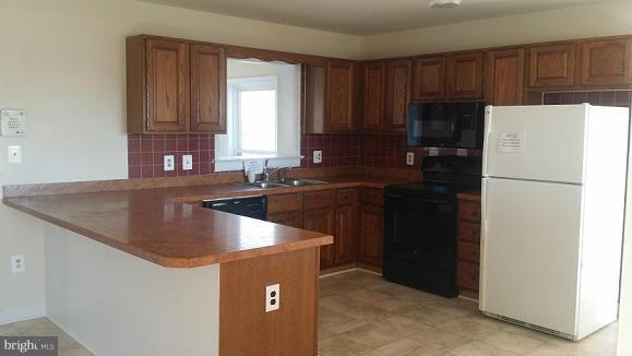 205 Berea Church Road Fredericksburg, VA 22406 - Photo 3 of 23 a kitchen with a sink a refrigerator a stove a microwave and cabinets