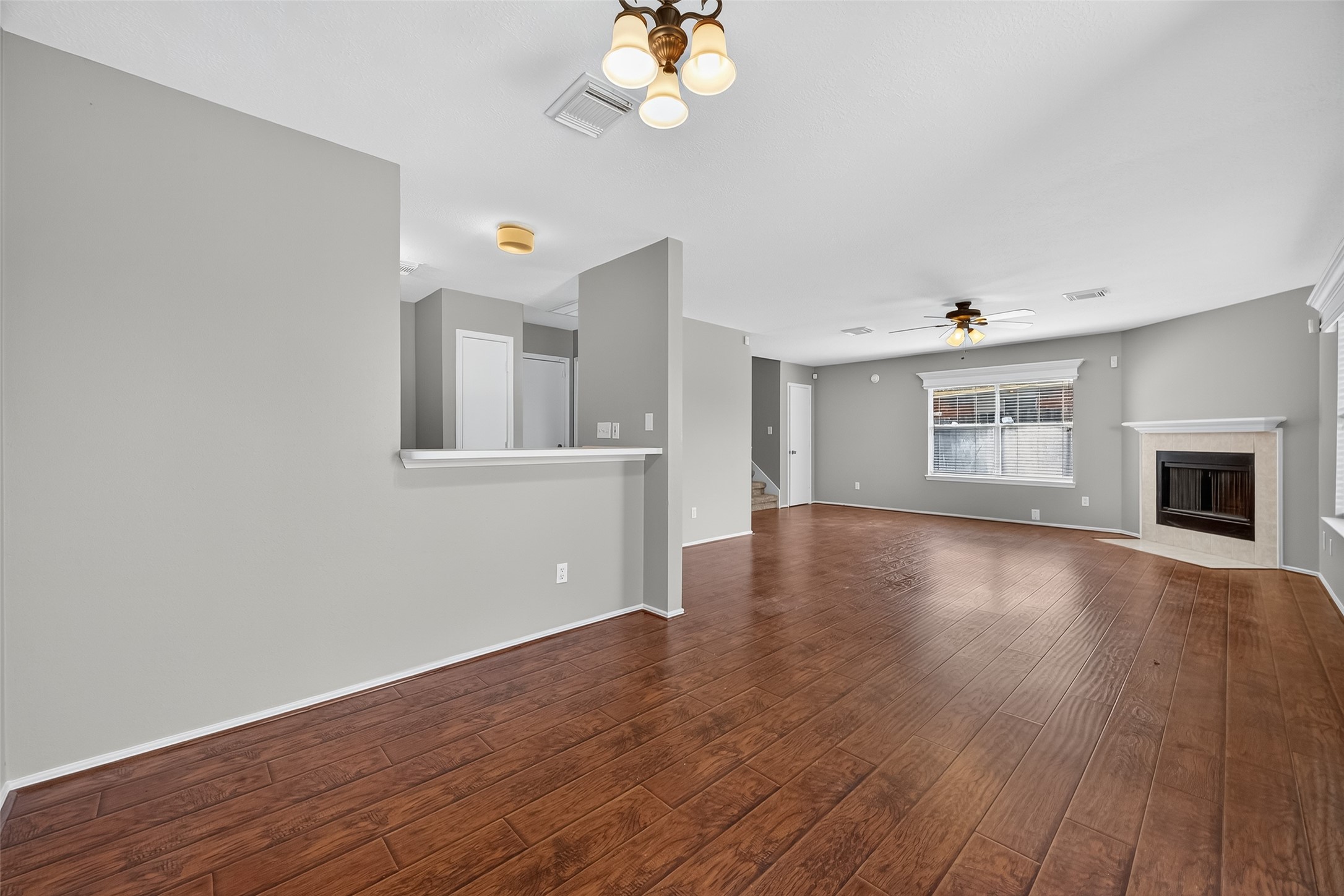 1107 Pennygent Lane Channelview, TX 77530 - Photo 11 of 40 a view of an empty room with wooden floor and a window