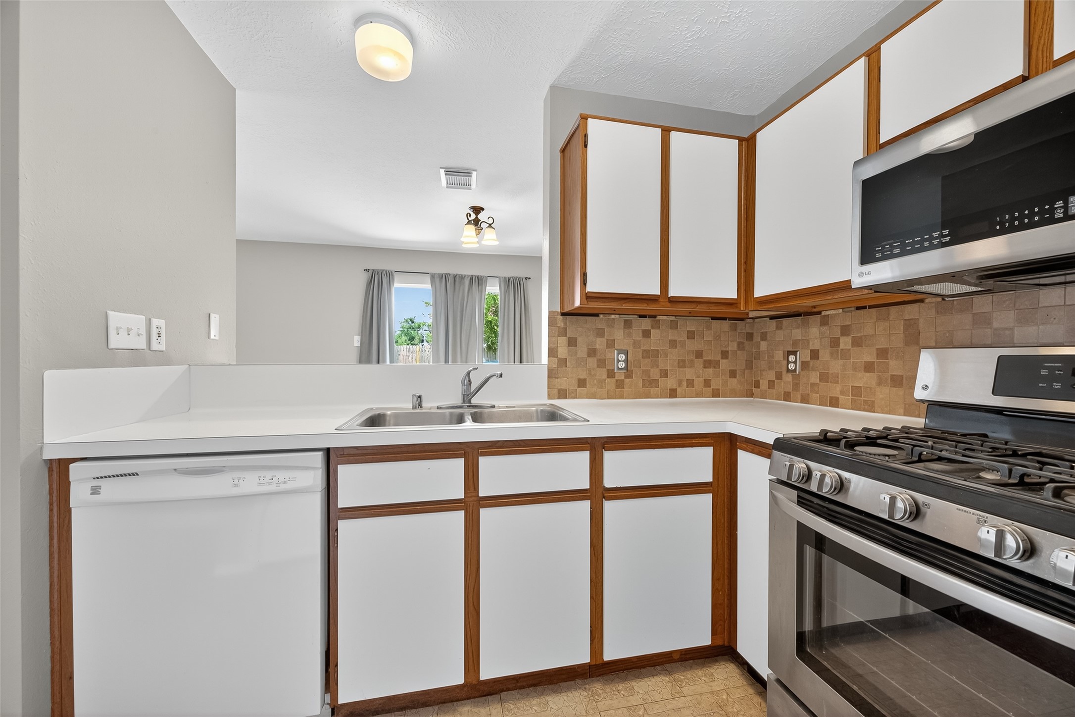 1107 Pennygent Lane Channelview, TX 77530 - Photo 14 of 40 a kitchen with a stove and a sink
