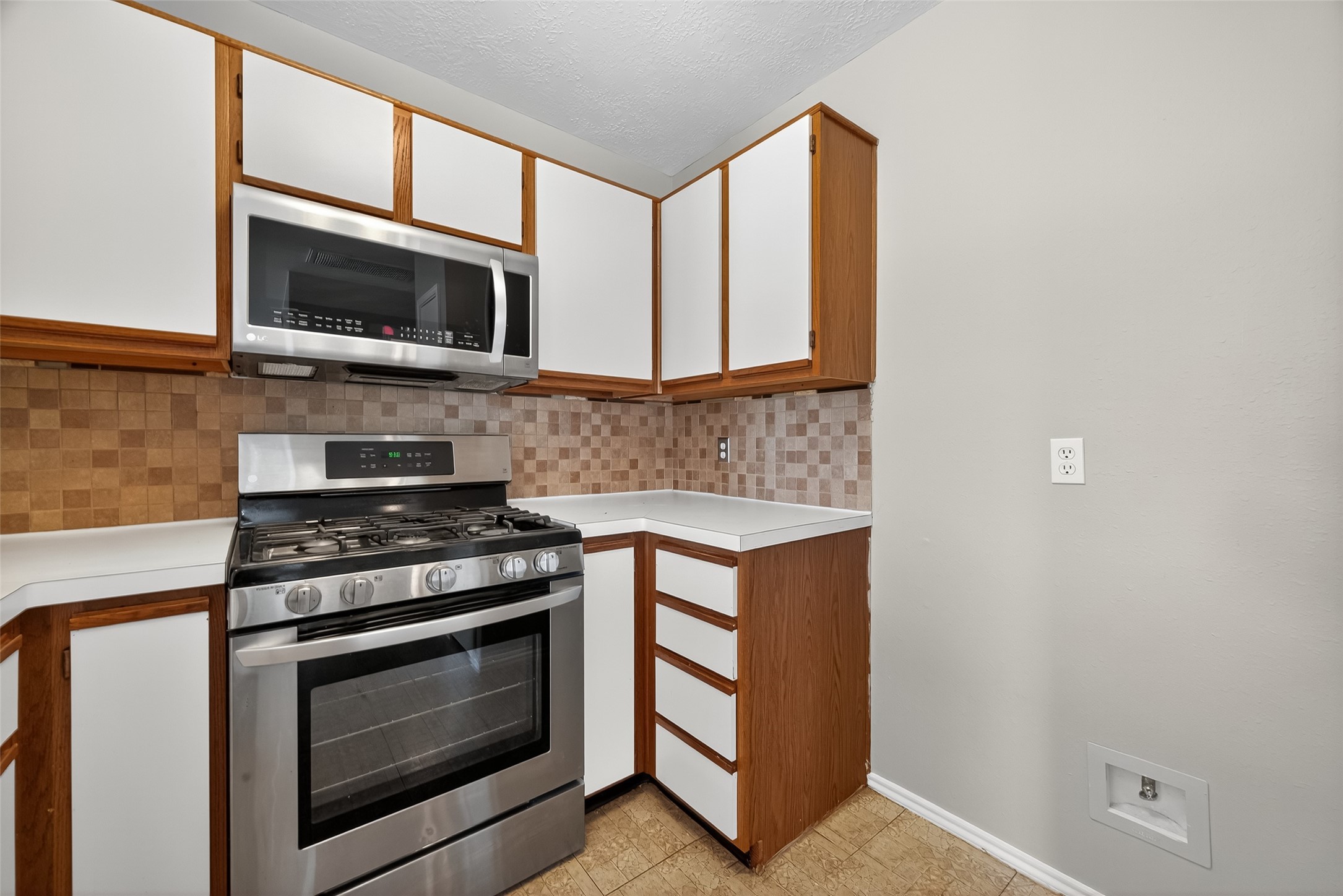 1107 Pennygent Lane Channelview, TX 77530 - Photo 15 of 40 a kitchen with stainless steel appliances granite countertop a stove microwave and sink