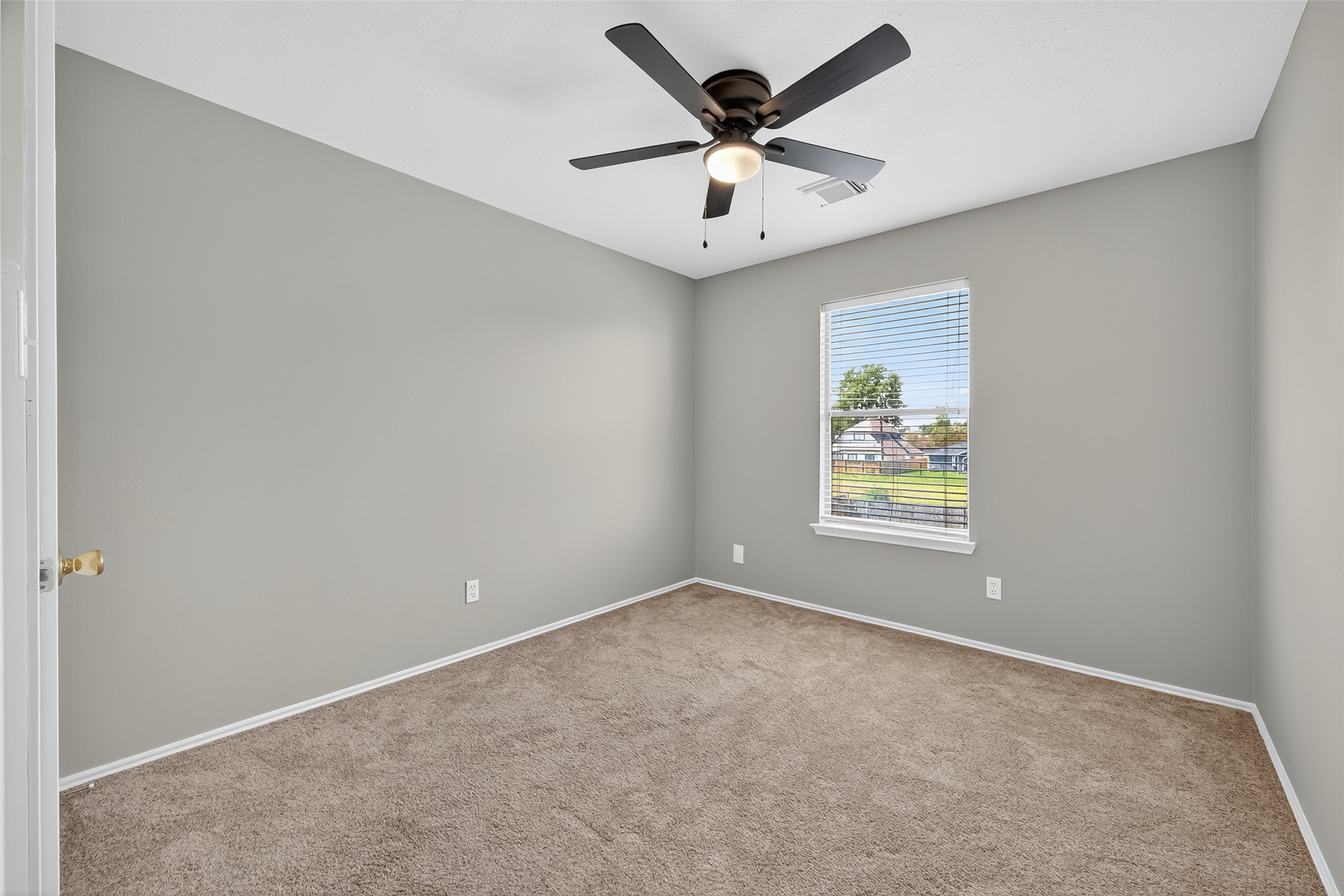1107 Pennygent Lane Channelview, TX 77530 - Photo 19 of 40 an empty room with a window and a ceiling fan