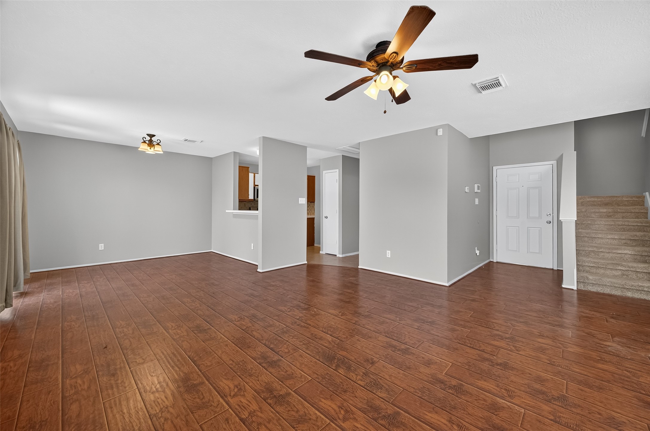 1107 Pennygent Lane Channelview, TX 77530 - Photo 7 of 40 a view of a livingroom with a ceiling fan & wooden floor