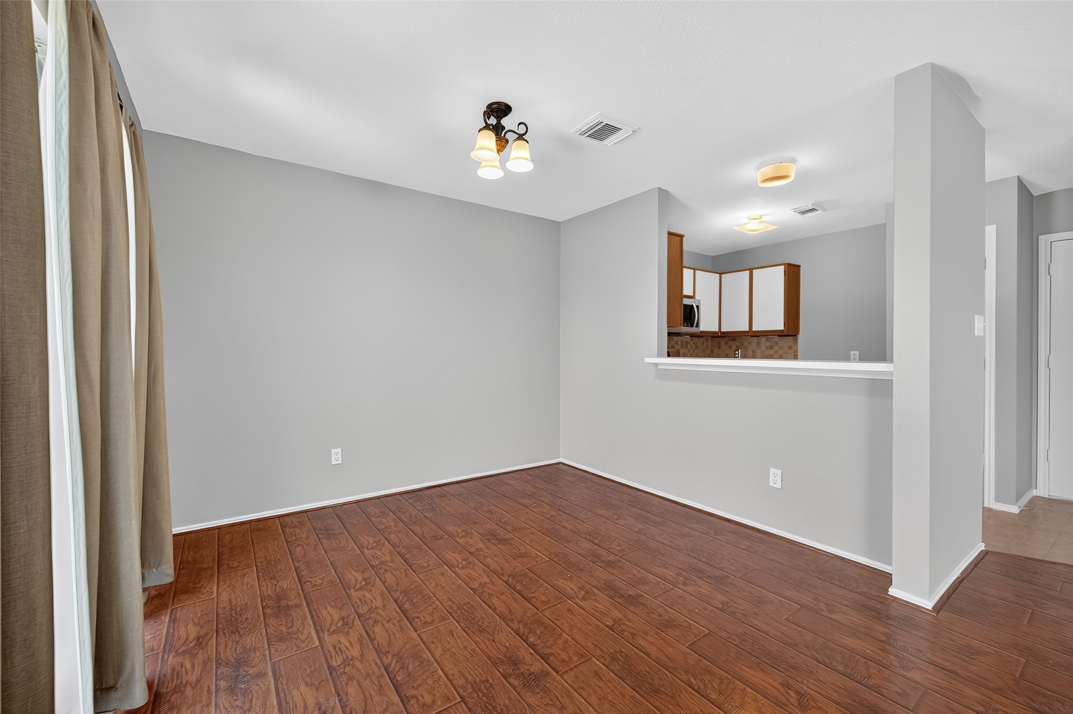 1107 Pennygent Lane Channelview, TX 77530 - Photo 9 of 40 a view of an empty room with wooden floor and a window