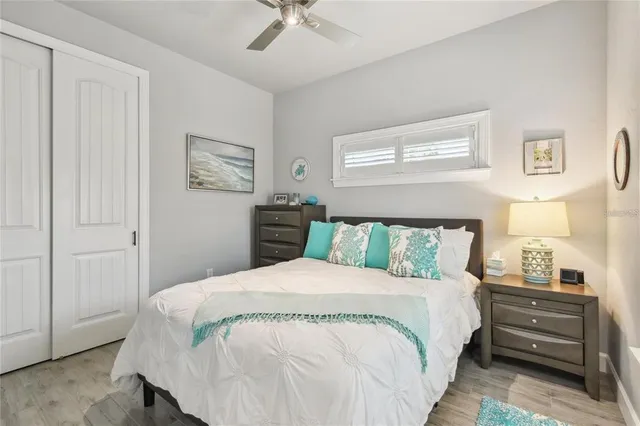 a large bed sitting in a bedroom next to a window