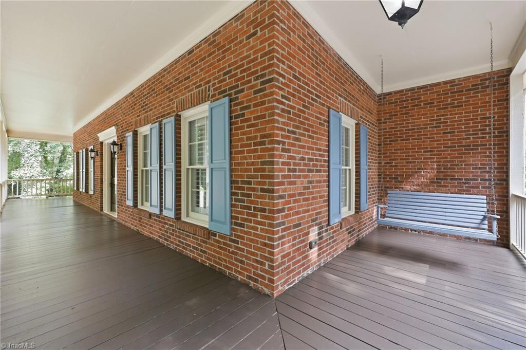 8861 Boylston Road Colfax, NC 27235 - Photo 6 of 50 A hallmark of the home's timeless design, the wraparound porch provides inviting spaces to unwind, entertain, or simply enjoy the tranquility of the property.