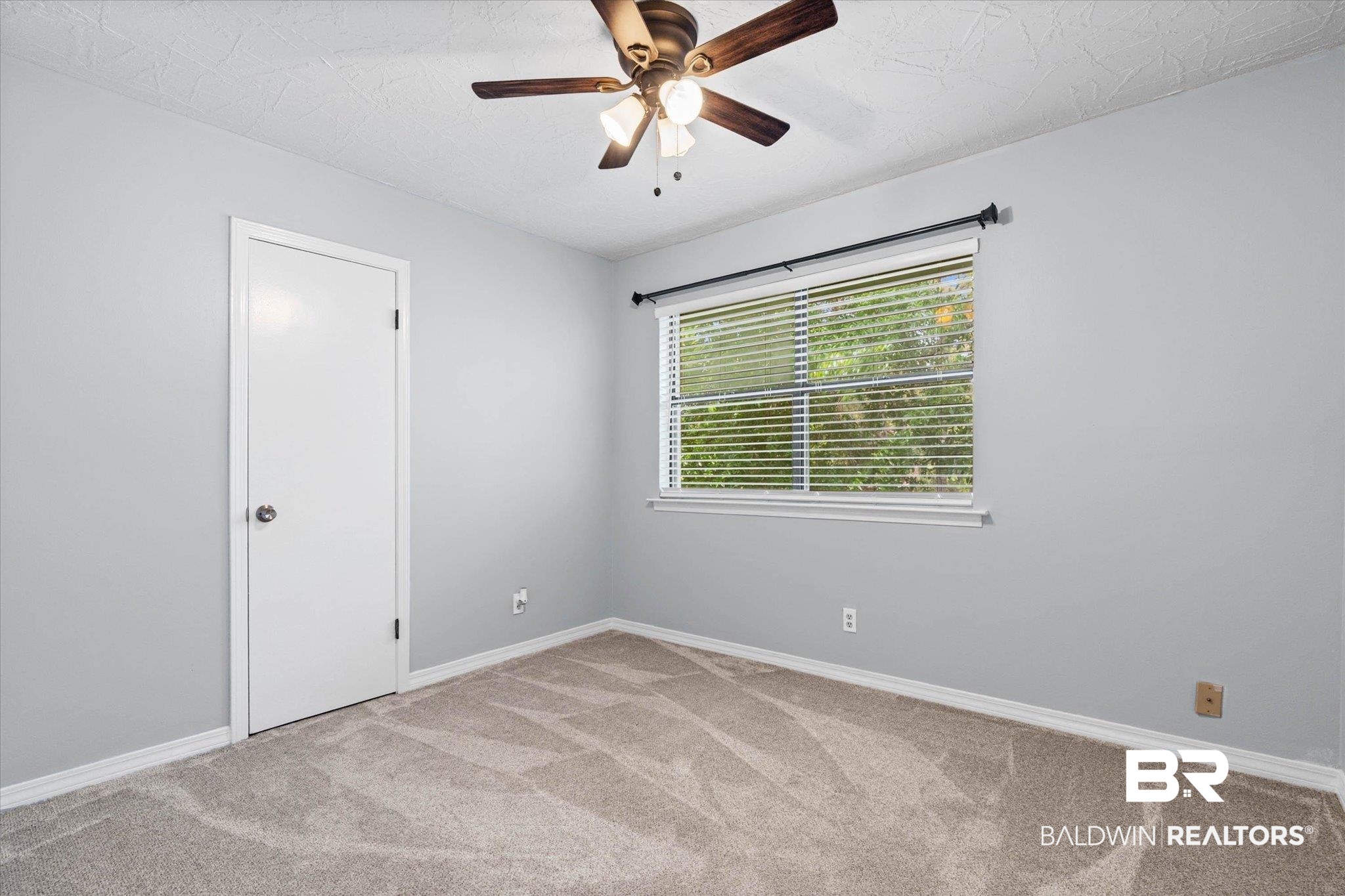 500 Grant Street, Unit C210 Daphne, AL 36526 - Photo 21 of 26 Carpeted room featuring light gray walls, white trim, a single window with horizontal blinds, and a ceiling fan with light fixture