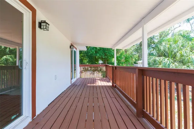 a view of balcony with wooden floor