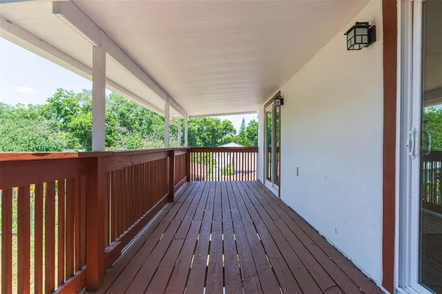 a view of balcony with wooden floor